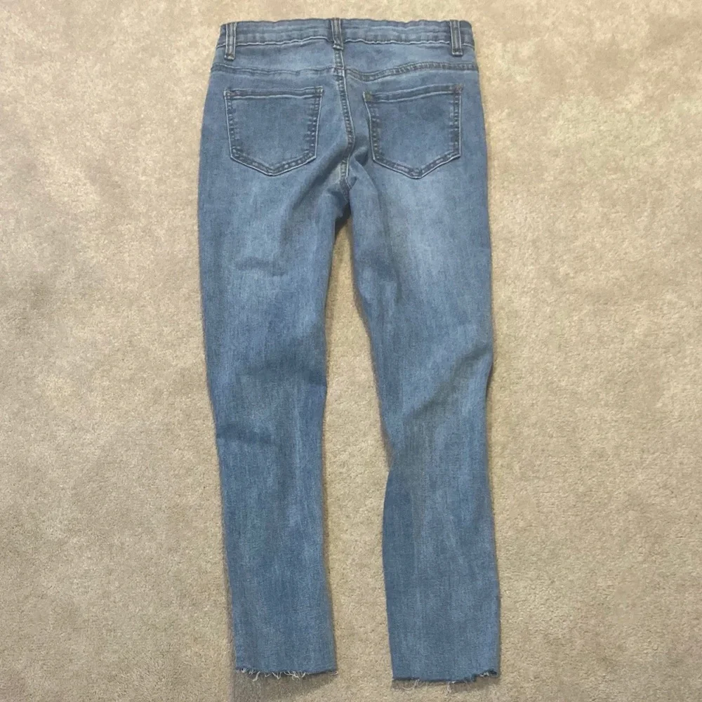 High Waisted Ripped Raw Hem Light Wash Skinny Jeans